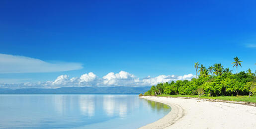 Empty white sand beach with blue skies and clear water, Philippines
