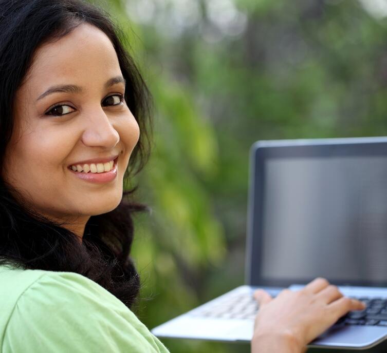 A woman smiling while looking at you